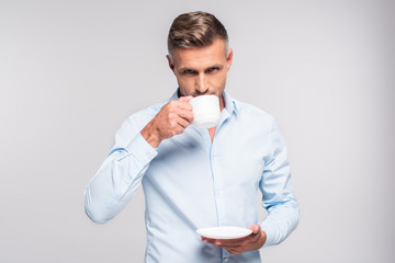 handsome adult man drinking coffee isolated on white