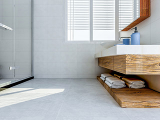 Solid wood washstand in the spacious bathroom with toiletries and green plants