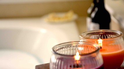 Candles, wine and cheese by the bathtub