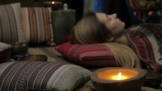 Woman operating with Tibetan singing bowls. yoga instructor conducts meditation. slow motion