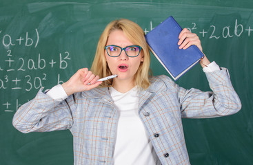 Educator woman hold book and pen chalkboard background. Inspired work harder or pursue particular goal. Learn be inspiring teacher. Inspiring educator spark motivation. Looking for inspiration