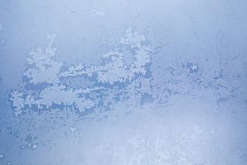 Winter ice pattern on the frozen window. Texture, background for inserting text. New Year theme. Winter. Cold.