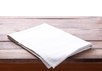 Table with white napkin isolated on white.