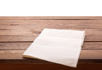 Table with white napkin isolated on white.