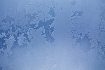 Winter ice pattern on the frozen window. Texture, background for inserting text. New Year theme. Winter. Cold.
