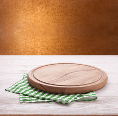 Kitchen towel and pizza board on wooden table. Napkin close up top view mock up. Kitchen rustic background.