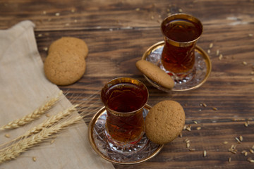 biscuits with two glasses of tea on wooden table as chat place
