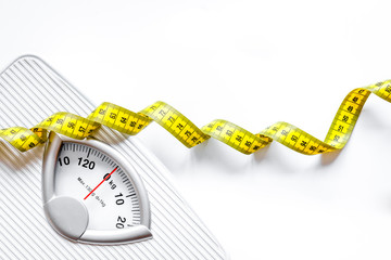 floor scale and apple on white background top view