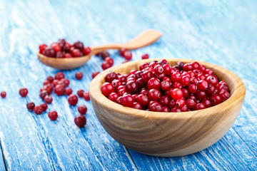 raw cranberries in a wooden plate