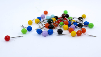  Various colored pins on white background