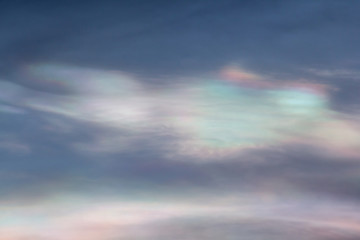 Cloud iridescence or irisation, polar stratospheric clouds on blue sky.