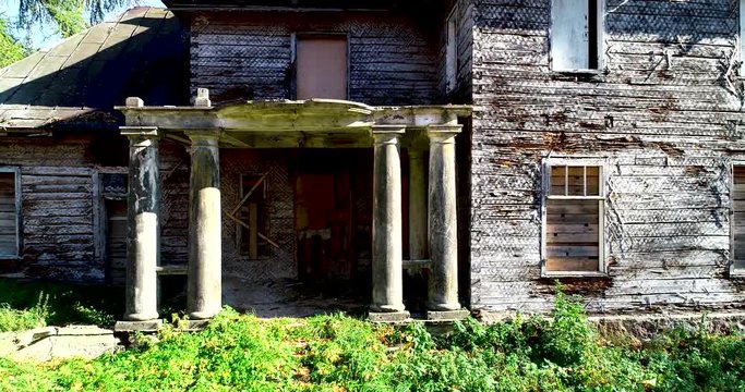 Abandoned old house with columns. Autumn. 4K. Aerial