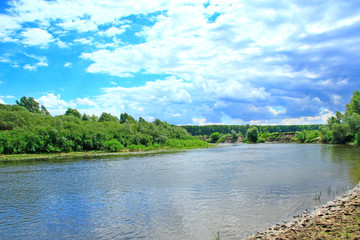 Landscape with river in summer. River landscape with white clouds