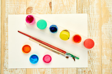 Watercolor palettes and paint brushes. Artist workplace