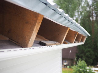 Construction of the frame house. Siding installation