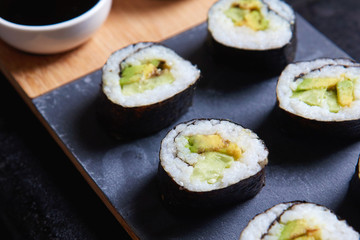 Vegan sushi rolls made with nori algae, sushi rice, cucumbers and avocado
