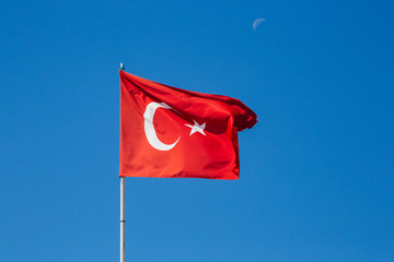Turkish Flag Waving on a  Blue Sky Background. Unusual Cloud on the Sky