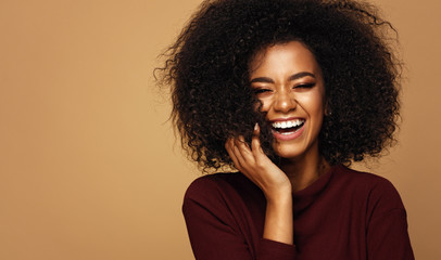 Portrait of laughing african american girl with copy space
