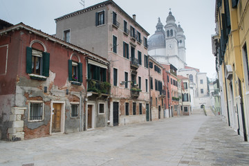 Fototapeta na wymiar VENICE, ITALY, Empty street of old Venice on winter misty day, Venice, Ita