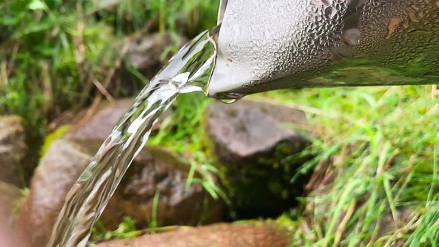 Water flows from a natural source, slow motion