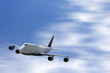 Big white airplane is flying over the clouds with colorful sky at sunset for Business trip with Commercial plane , Transportation, import-export and logistics, Travel concept