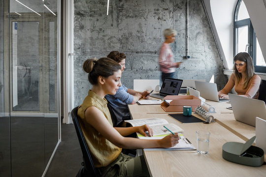 Group of businesspeople working at modern open space office.