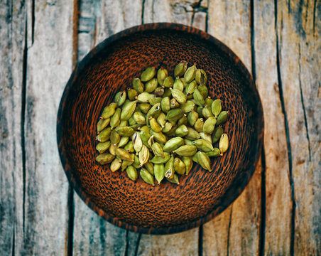 Cardamom Capsules In Wooden Bowl