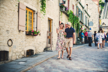 Fototapeta na wymiar Outdoor lifestyle portrait of young couple in love in old town