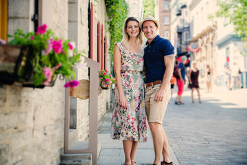 Outdoor lifestyle portrait of young couple in love in old town