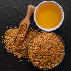 seeds of golden flax on a dark stone background