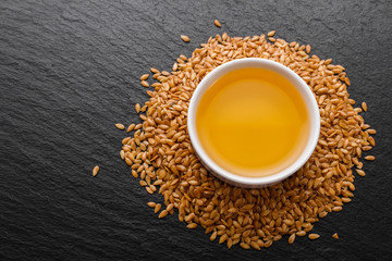 seeds of golden flax on a dark stone background