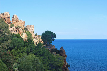 Fototapeta na wymiar mediterranean view with blue sea, rocks and ruins of a castle
