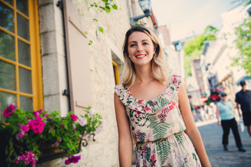 Fashion woman portrait of young pretty trendy girl posing on the quebec city street