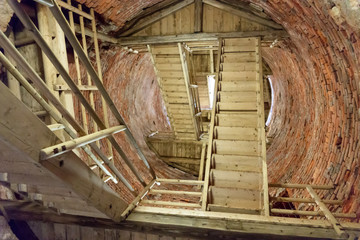 Wooden staircase in a round stone tower