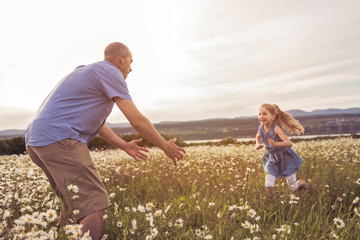 Father spending time with daughter during the sunset.