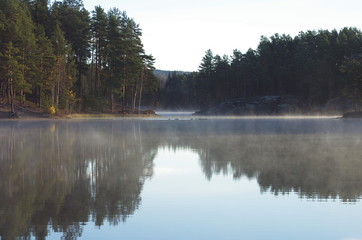 Fototapeta na wymiar Morning mist over a lake in Dalarna