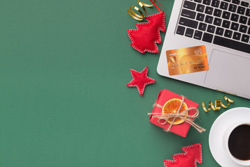 Laptop, credit card and christmas decorations, top view