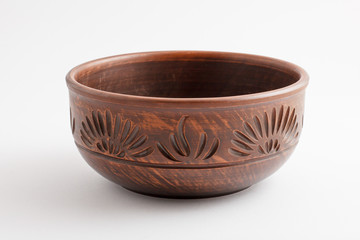 Beautiful clay bowl with patterns on white background