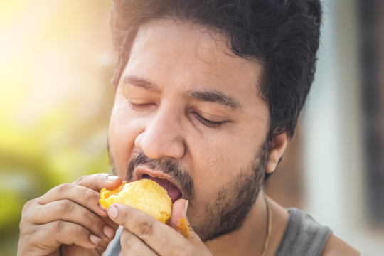 Indian Man Eating Mango.