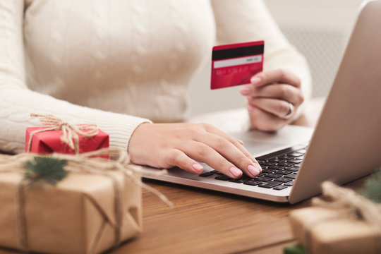 Online orders for Christmas. Woman buying presents
