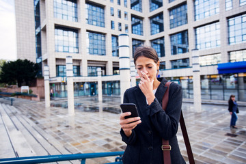 Worried business woman using phone