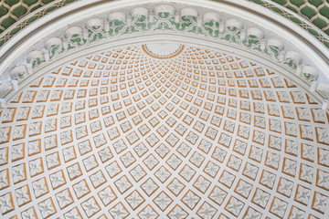 The texture of the old arch. Fragment of the facade of an old building with stucco decoration.