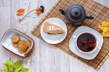 Old black teapot on the straw bedding.