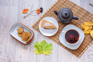 Old black teapot on the straw bedding.