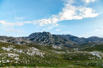panoramic view of green valley with stones in Durmitor massif, Montenegro