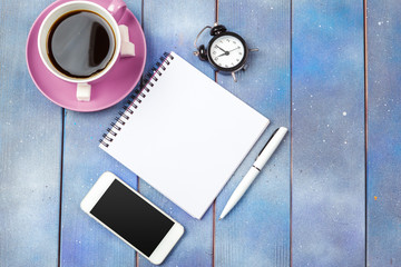 Modern workplace with cup of coffee on wooden table