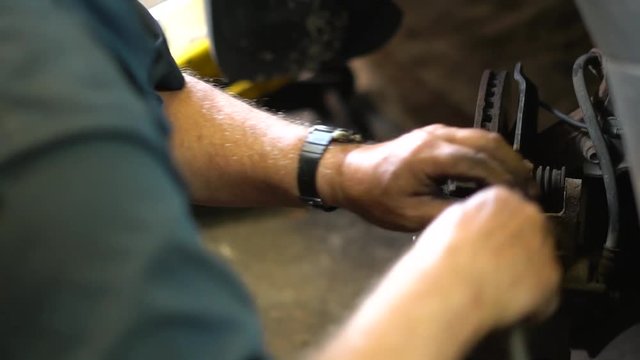 Car Mechanic Performing Brake Change