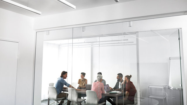 Group of young businesspeople having a meeting at meeting room.