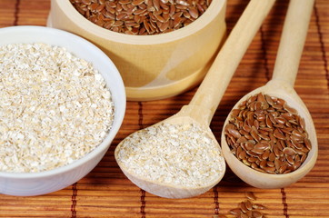 Flax seeds and oat bran on bamboo napkin close-up