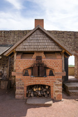 Old traditional brick oven on the empty barbecue place